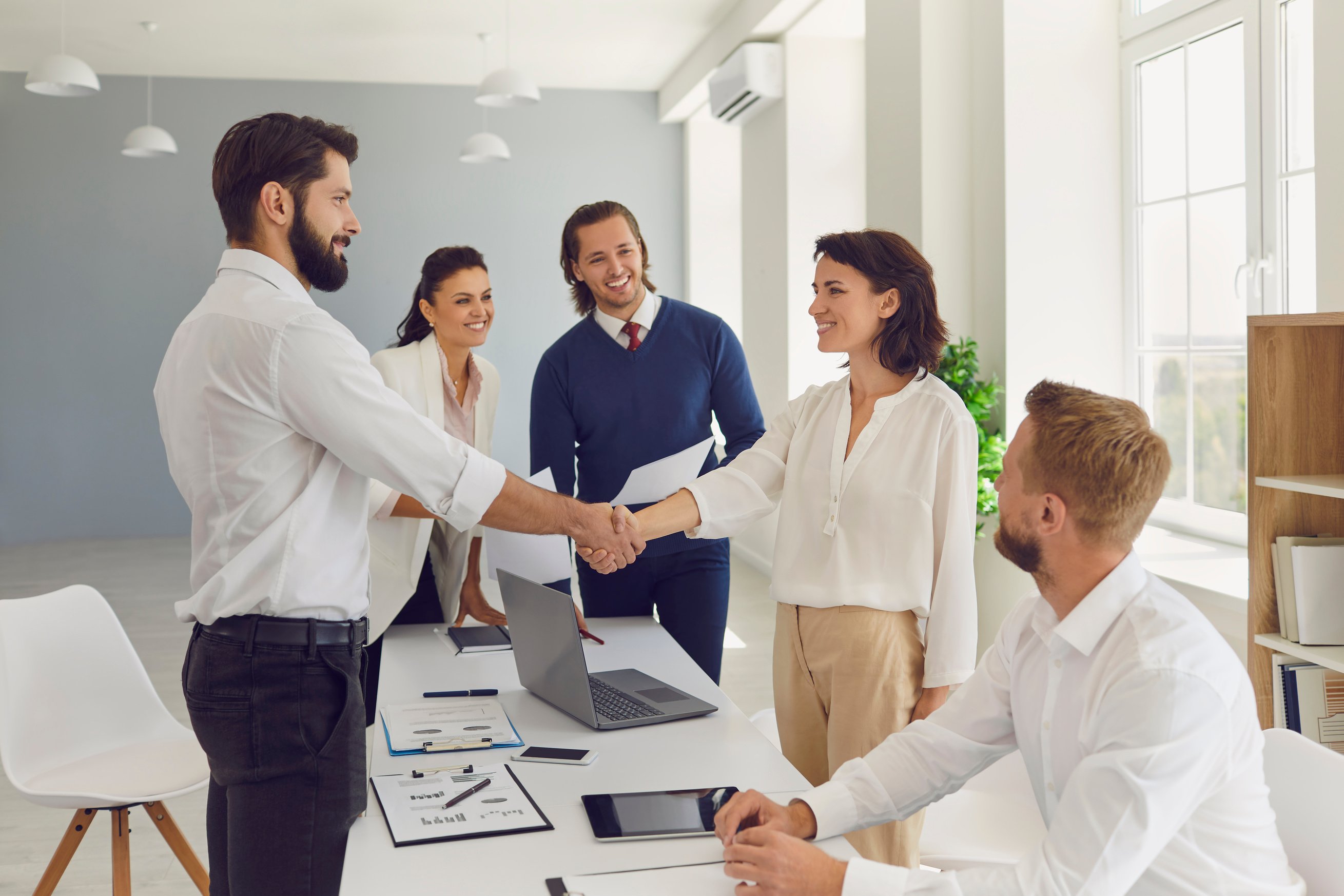 Friendly Businesspeople Shaking Hands Confirming a Business Deal in a Negotiation Meeting